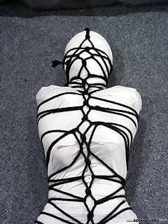 16 of Pretty brunette Ann is wrapped up tightly head to toe in crepe bandages.