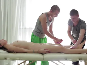 Two men give a steamy massage with oil to a beautiful woman and then they proceed to have sex with her.